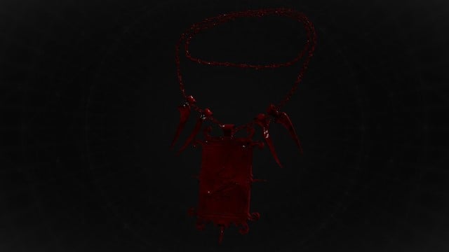 A dark-red amulet in Remnant 2 sits on a black background.