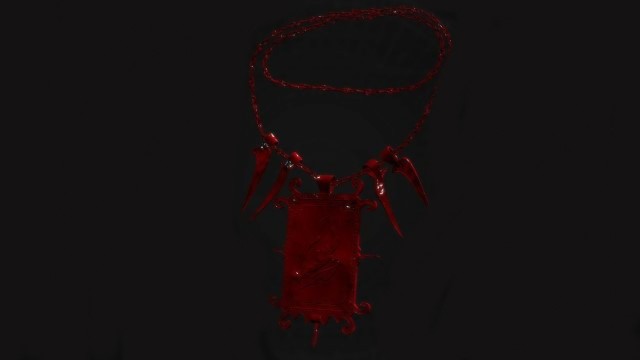 A red amulet with a cylindrical centerpiece sits on a black background in Remnant 2.