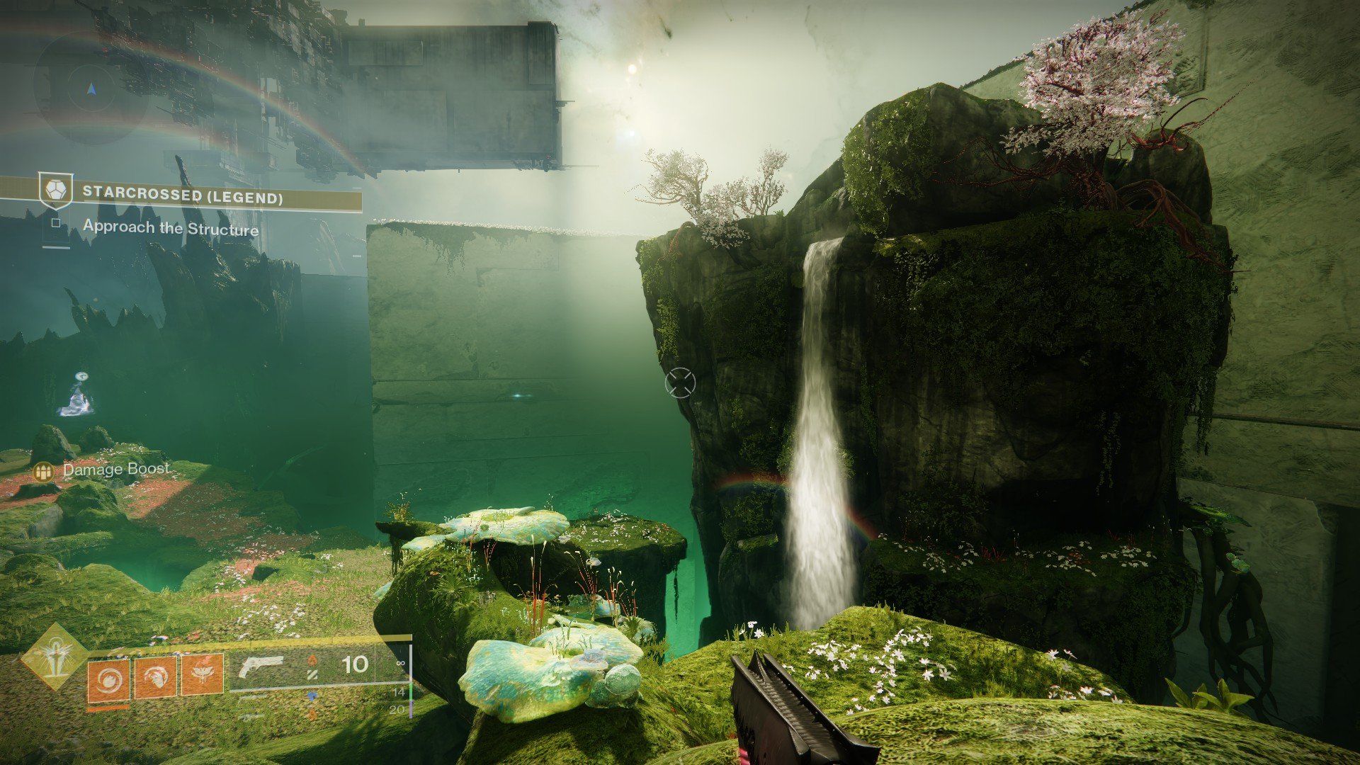 A cliff in the Black Garden with a waterfall on it. The dragon icon from Last Wish is visible on the left side of the screen.