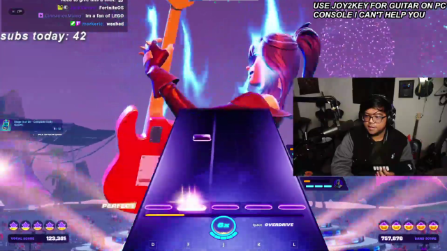 YouTuber Acai playing Fortnite Festival with a Guitar Hero custom controller.