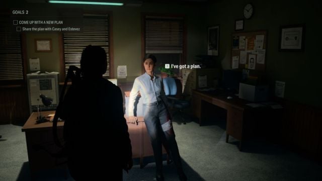 An in game screenshot from Alan Wake 2 that shows Saga speaking with Estevez in the Sheriff's Station.