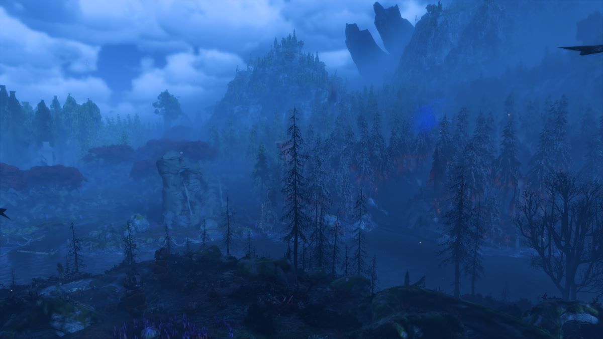 Evergreen trees on a foggy blue night in the mountains in Avatar: Frontiers of Pandora.