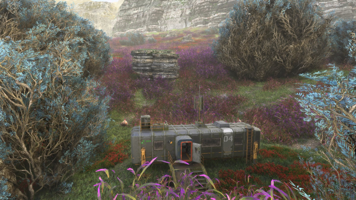A cabin in the grasslands surrounding by bushes in Avatar: Frontiers of Pandora.