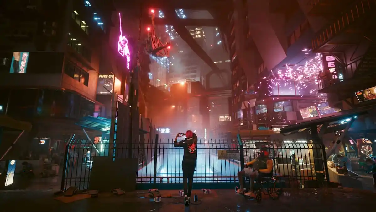 A person standing in Night City with their hands forming a heart in Cyberpunk 2077.