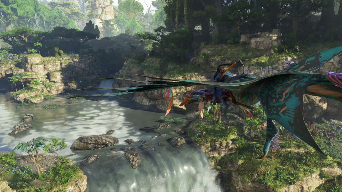 A Na'vi riding an Ikran above a waterfall in the jungle in Avatar: Frontiers of Pandora.