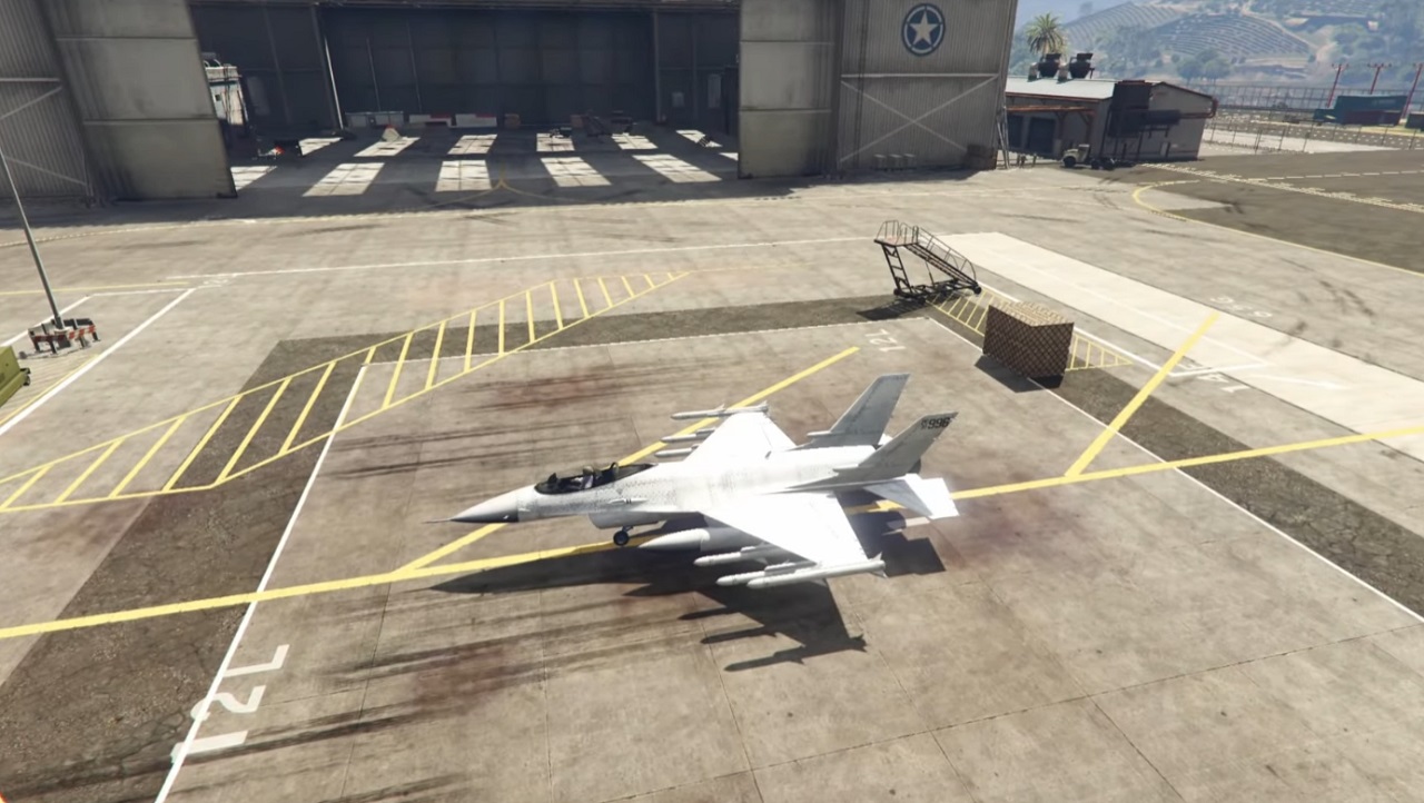 There is a shot of a fighter jet that is starting up at a military base.