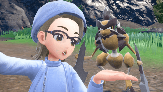 The player character in Pokemon SV stands in front of a Kleavor with her hand out.