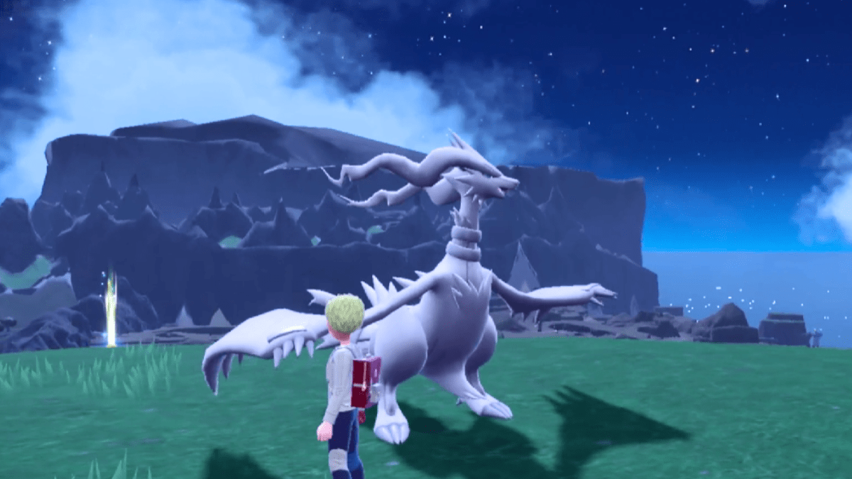 Reshiram standing in the grass near a trainer in Pokémon Scarlet and Violet