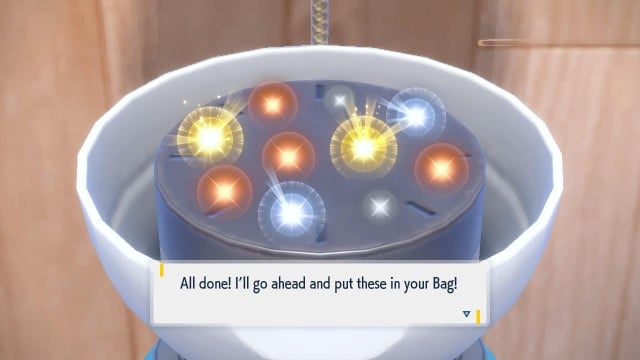 A pile of glowing items for the player sits inside of a Pokéball-like machine in Pokémon Scarlet and Violet.