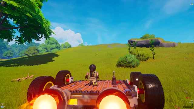 A Lego character is driving a car in Lego Fortnite