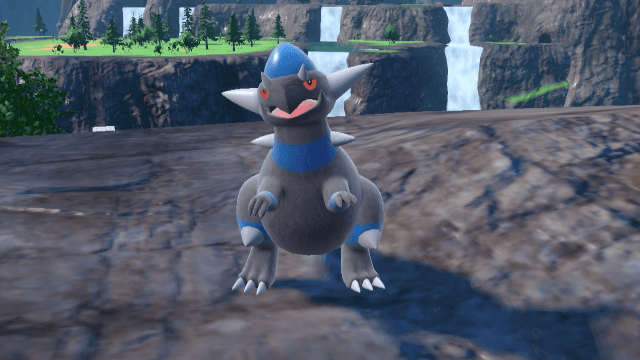 Rampardos stands on a cliff's edge in Pokemon Scarlet and Violet: The Indigo Disk