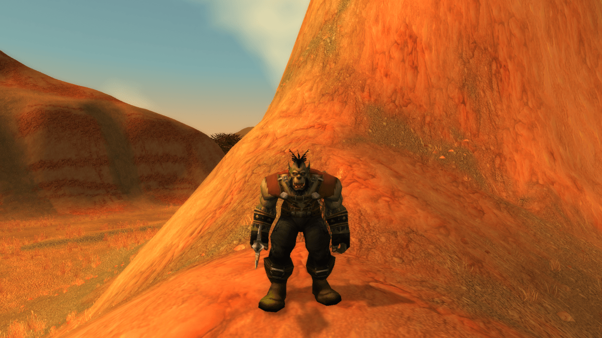 Image of an Orc Hunter standing on the side of a mountain in WoW SoD.