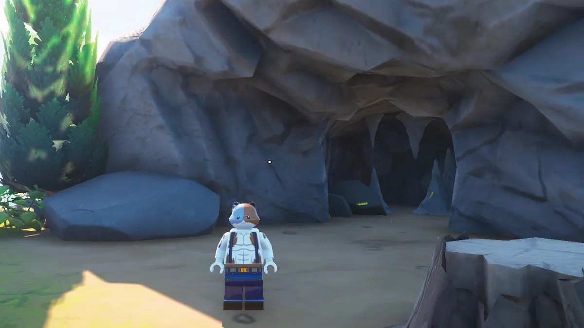A cat sitting in front of a cave in LEGO Fortnite.