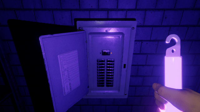 The player holding a UV Light and looking at a fuse box in Phasmophobia.