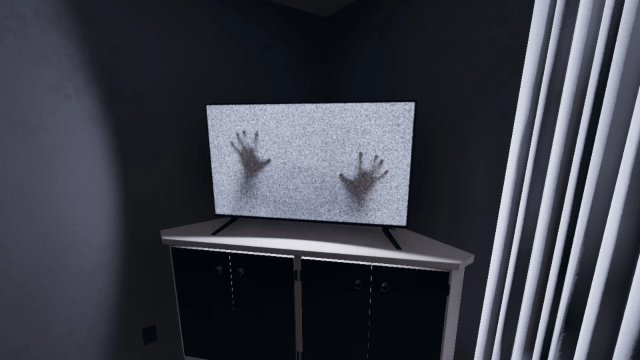 A pair of hands sticking out of a TV set in Phasmophobia.
