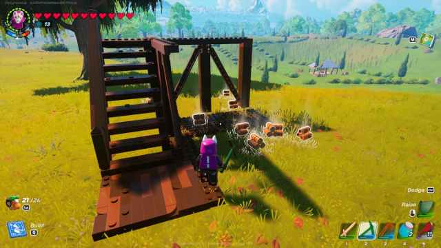 A half destroyed watchtower with wood lying on the ground in LEGO Fortnite