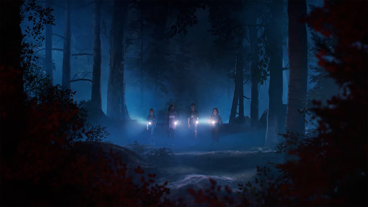 Four girls hold flashlights i the woods at night.