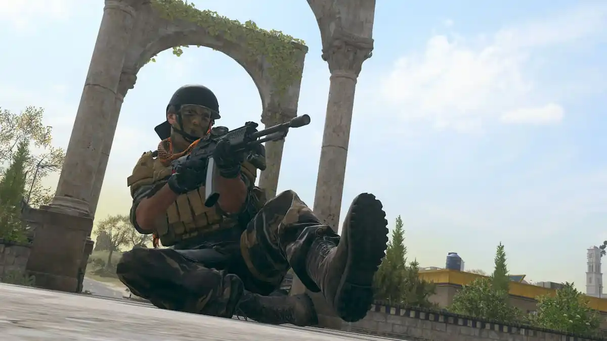 A screenshot of a CoD MW3 operator sliding and shooting.