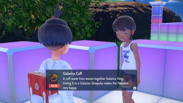 A screenshot of Pokémon SV showing the player character receiving a Galarica Cuff from and NPC.