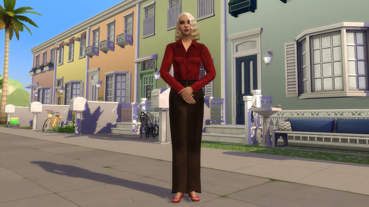 A property manager standing in front of a row of townhouses they own.
