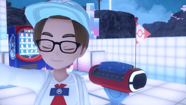 A boy stands in front of a healing machine in a blocky area of Pokémon Scarlet and Violet.