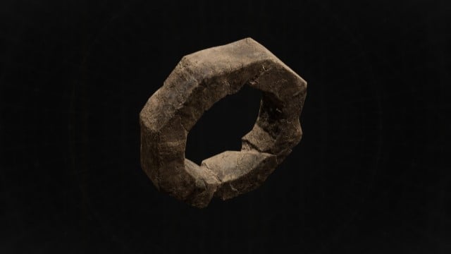 A circular, bronze ring sits on a black background in Remnant 2.