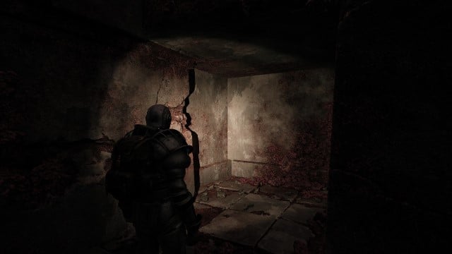 A man in heavy armor stares at the corner of a ruin in Remnant 2.