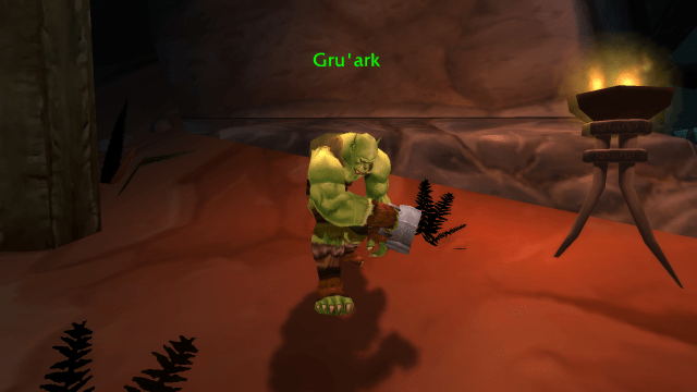 Image of an Orcish person standing with a cub.