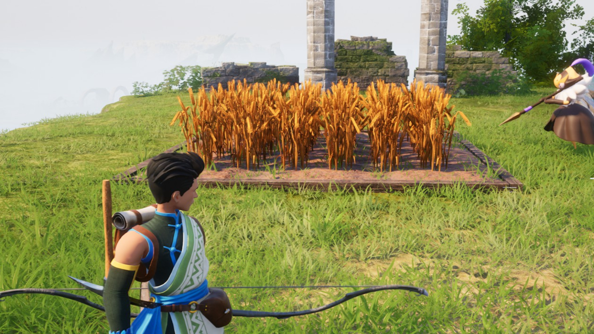 A player in Palworld looking over a field of Wheat.