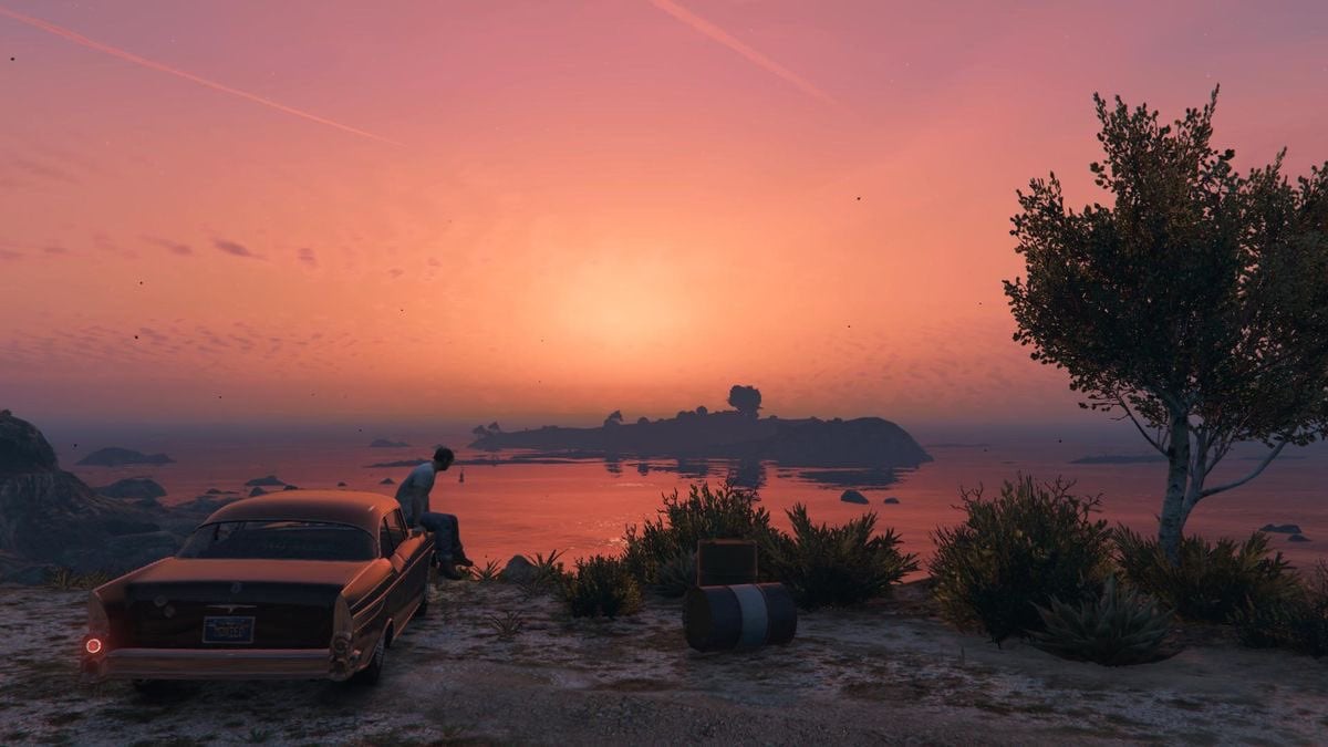 Sunset of Los Santos taken in Grand Theft Auto V. There is a car and a tree in the background.