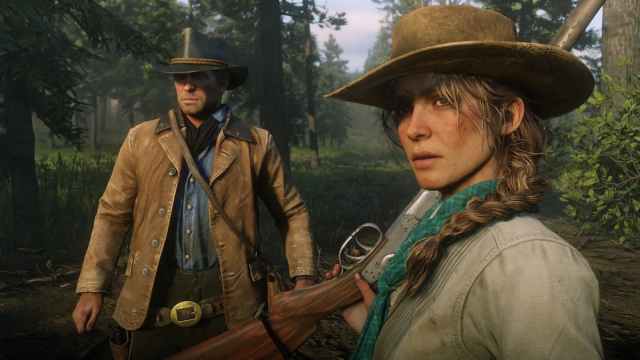 An in game image of Arthur Morgan and Sadie Adler from Red Dead Redemption 2.