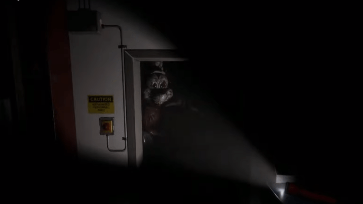 Image from Infestation: Origins trailer, showing a horror version of Mickey Mouse in a doorway illuminated by a torch.