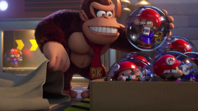 Donkey Kong holds a ball with a toy Mario inside.