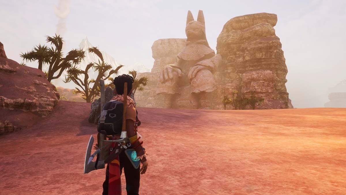 A player in the desert in Palworld looking at an Anubis statue.