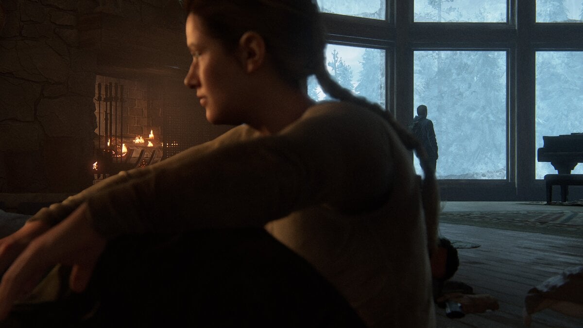 Abby waking up inside the ski lodge with Owen in the background in TLOU 2 Remastered