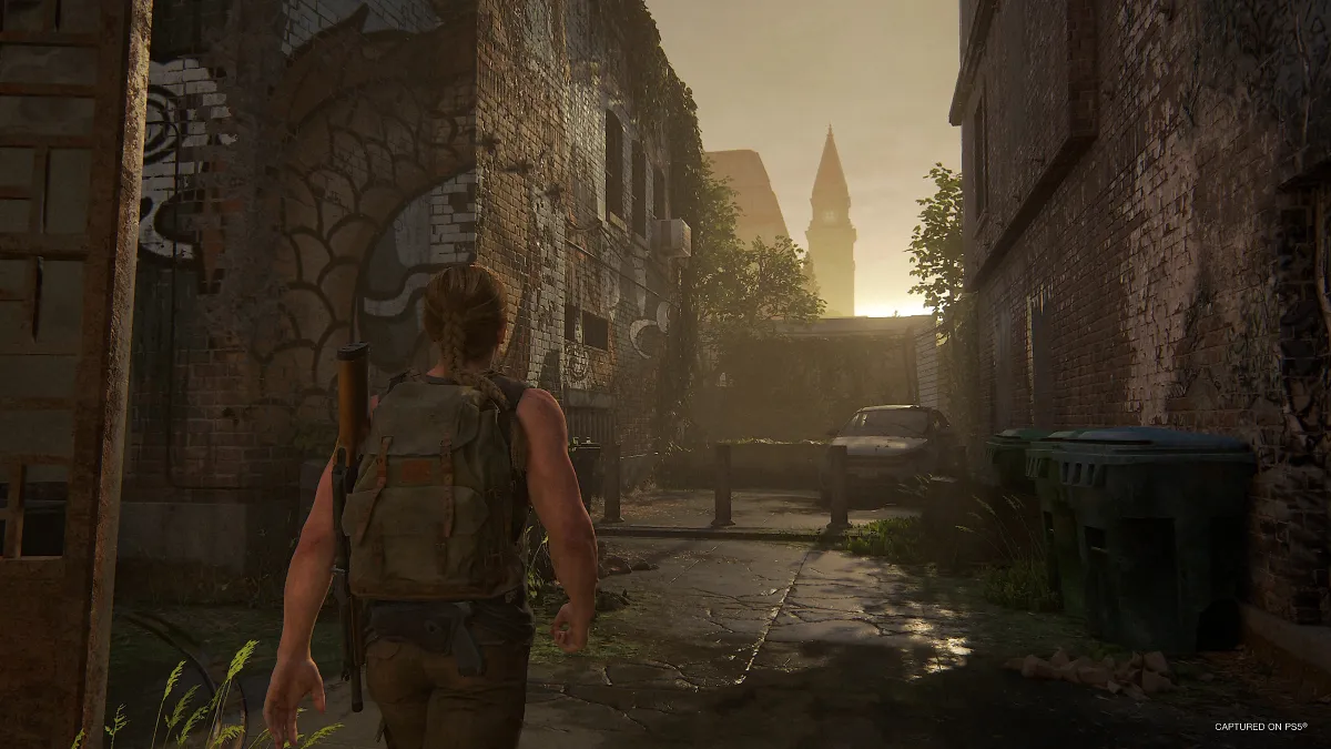 Abby walking through a town in The Last of Us 2 Remastered.
