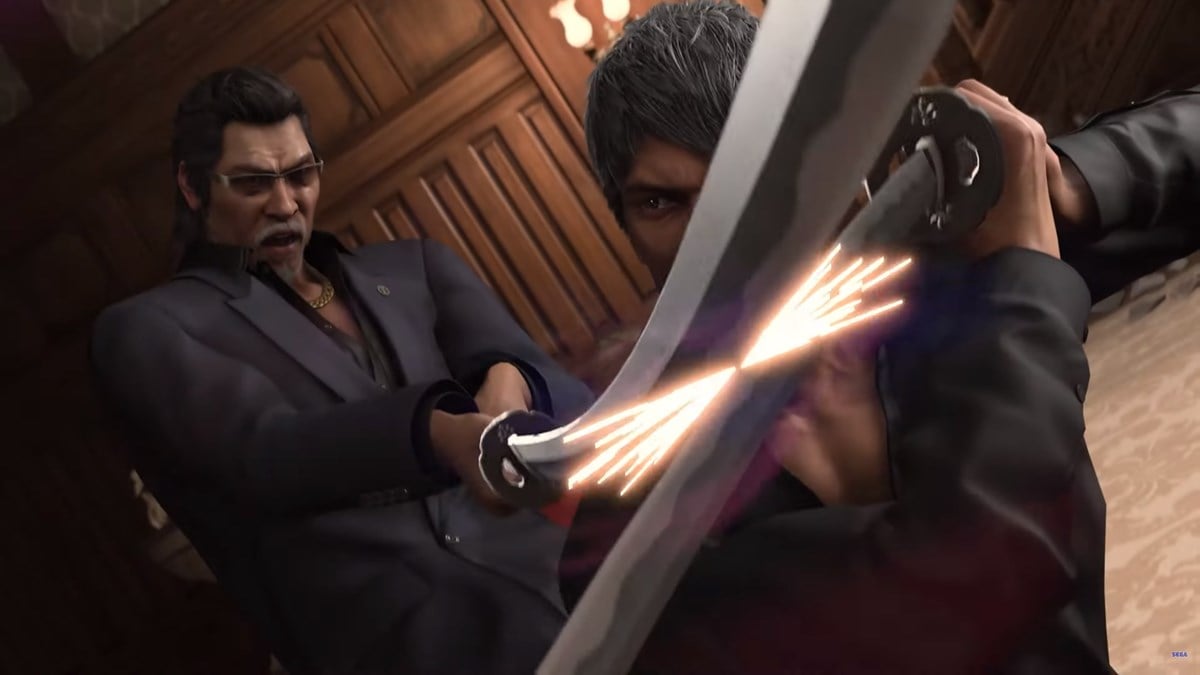 Kiryu is holding a sword blocking an enemies attack