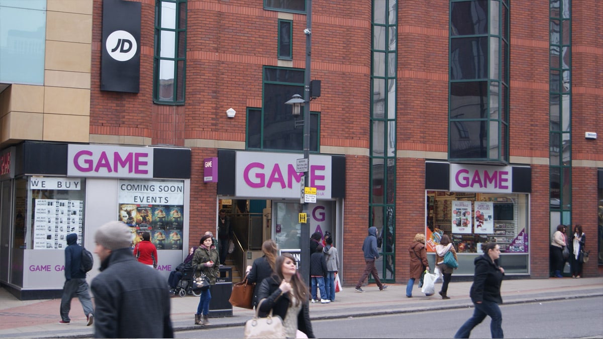 A GAME store in the UK as people walk around outside.
