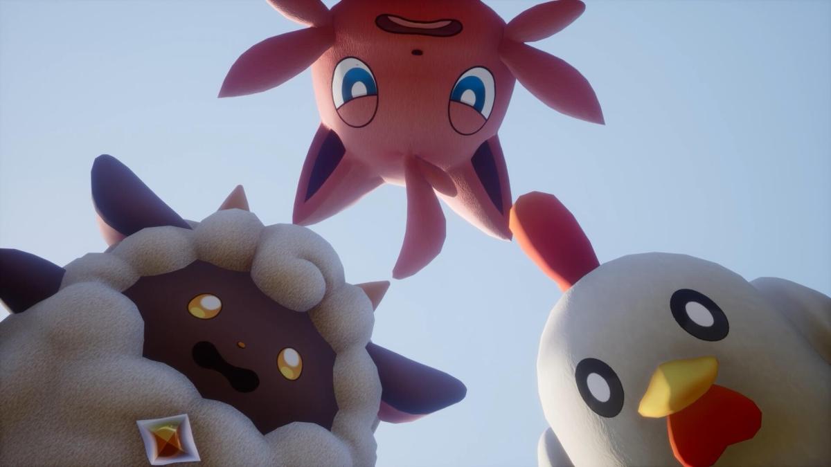 A close-up image featuring three animated creatures looking downwards with a clear blue sky in the background, reminiscent of characters from a creature-collecting video game.