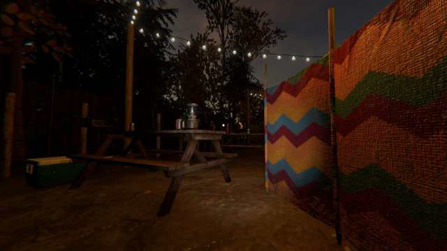 A player crouched behind a rainbow divider near some picnic tables with lit string lights hanging above them in Phasmophobia.