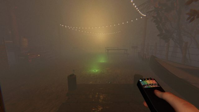 The player holding an EMF Reader while looking at equipment including a Sound Sensor and DOTS Projectors in the ghost room which is the pier area at Maple Lodge Campsite in Phasmophobia.