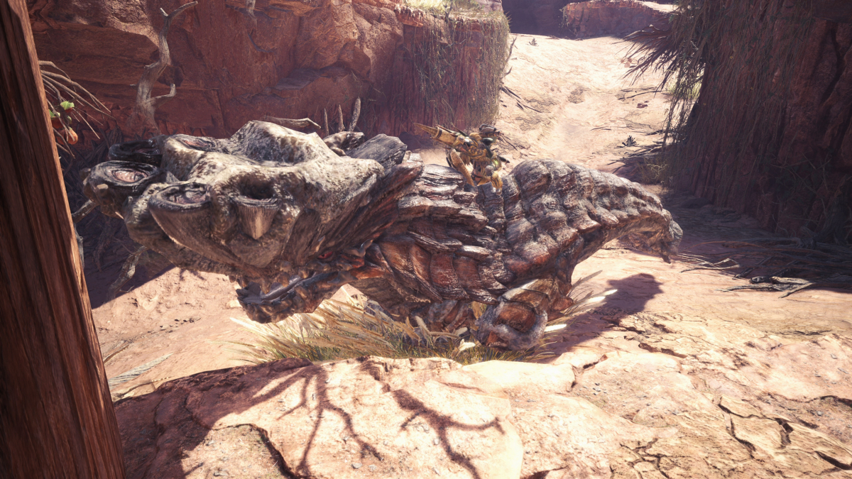 A player in Monster Hunter World on the back of a Barroth.