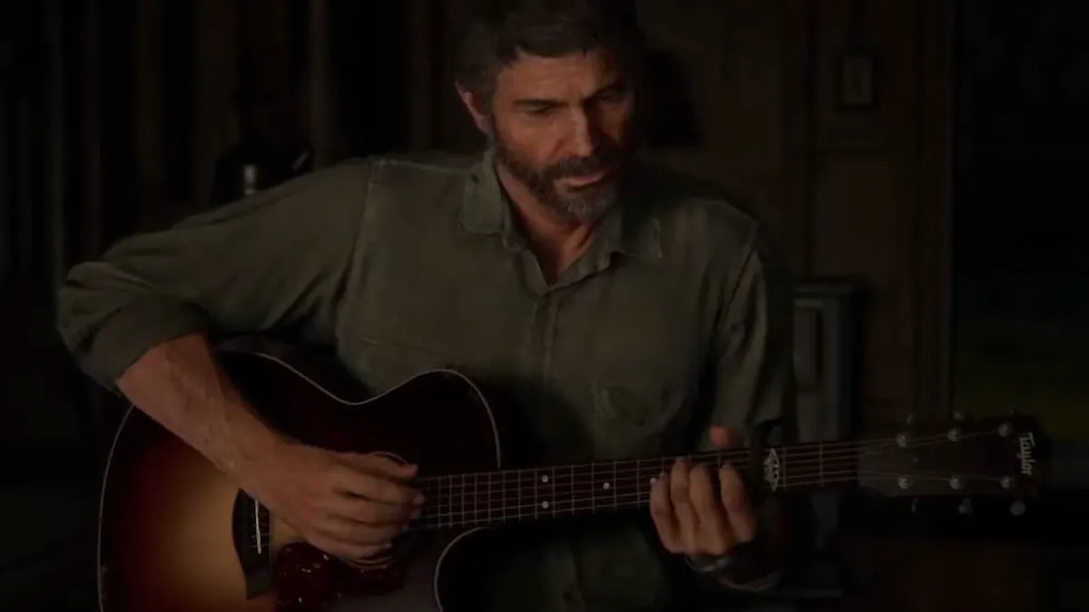 Joel playing the guitar in The Last of Us Part 2.