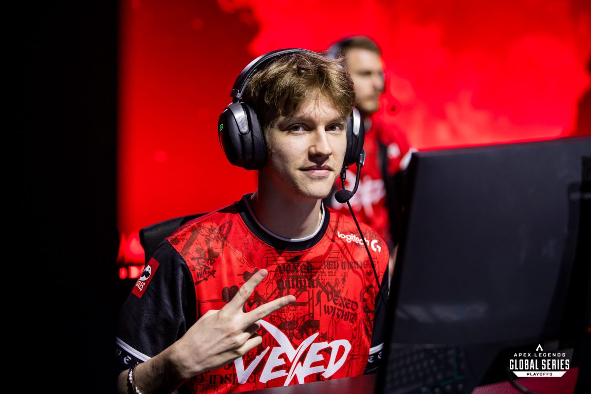 Vexed's Unlucky flashes a peace sign to the camera while playing in ALGS.