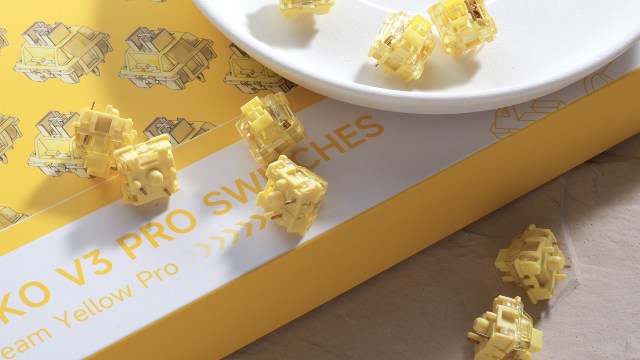 Akko V3 Cream Yellow Pro linear switches scattered next to a plate