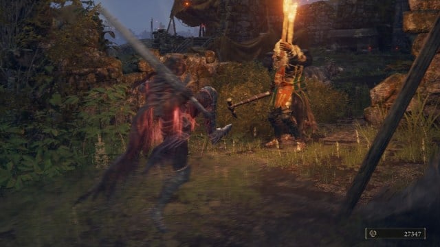 A Knight prepares to stomp on the ground in front of two soldiers in Elden Ring