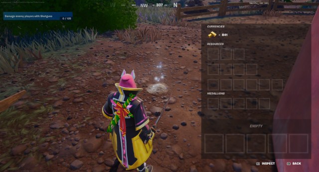 A Fortnite character, wearing a black and yellow jacket, looking at a Mosaic Cache in Fortnite.