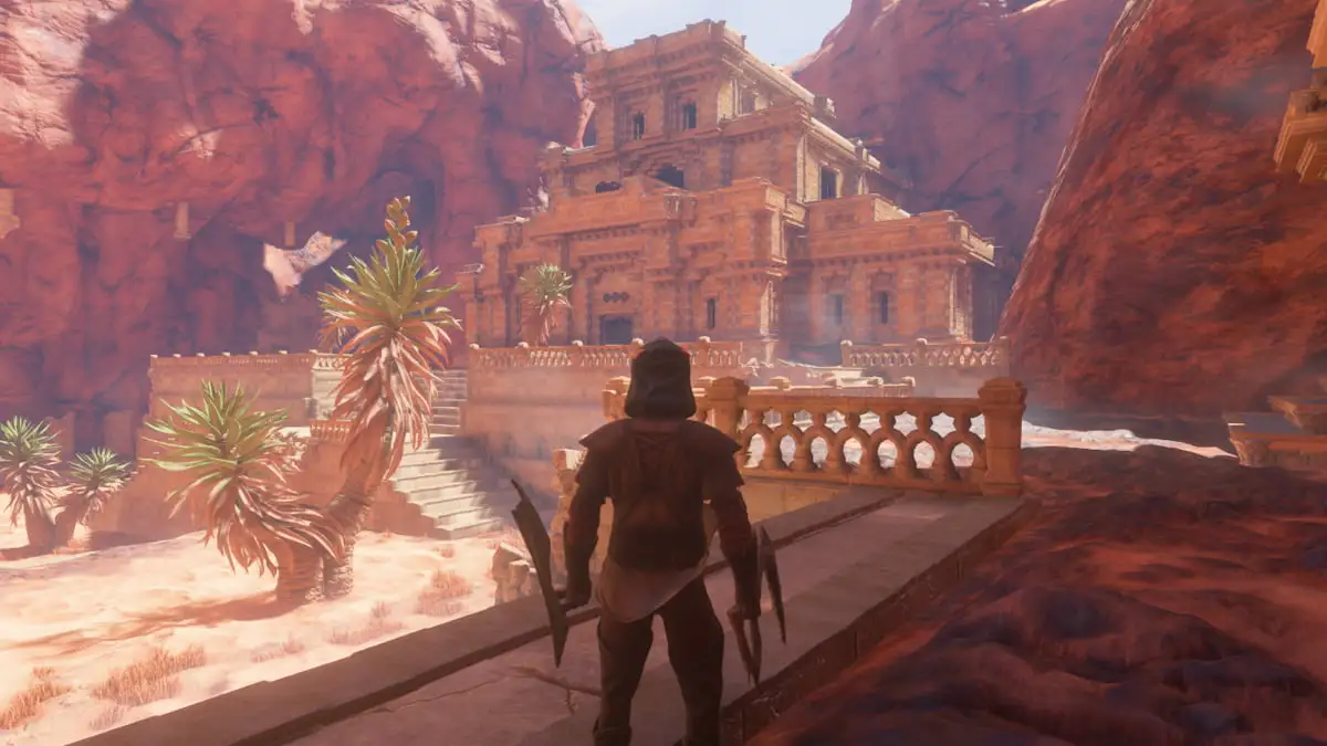 A player stands outside a temple-like structure in a rocky mountain range in Enshrouded.