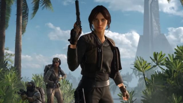Image from Star Wars Battlefront trailer showcasing Jyn Erso. Characters are currently on the beach and a weapon is visible in the hands of Jyn Erso.