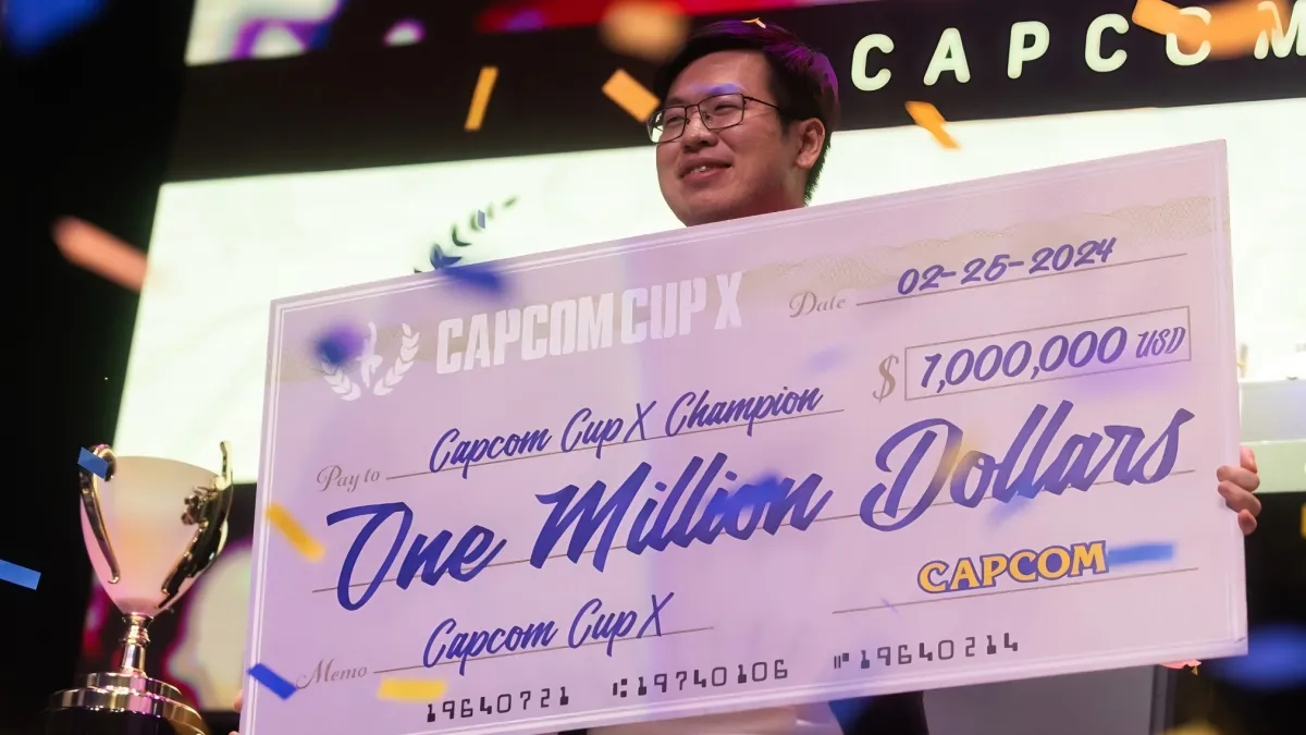 UMA holding a $1 million check at Capom Cup X.